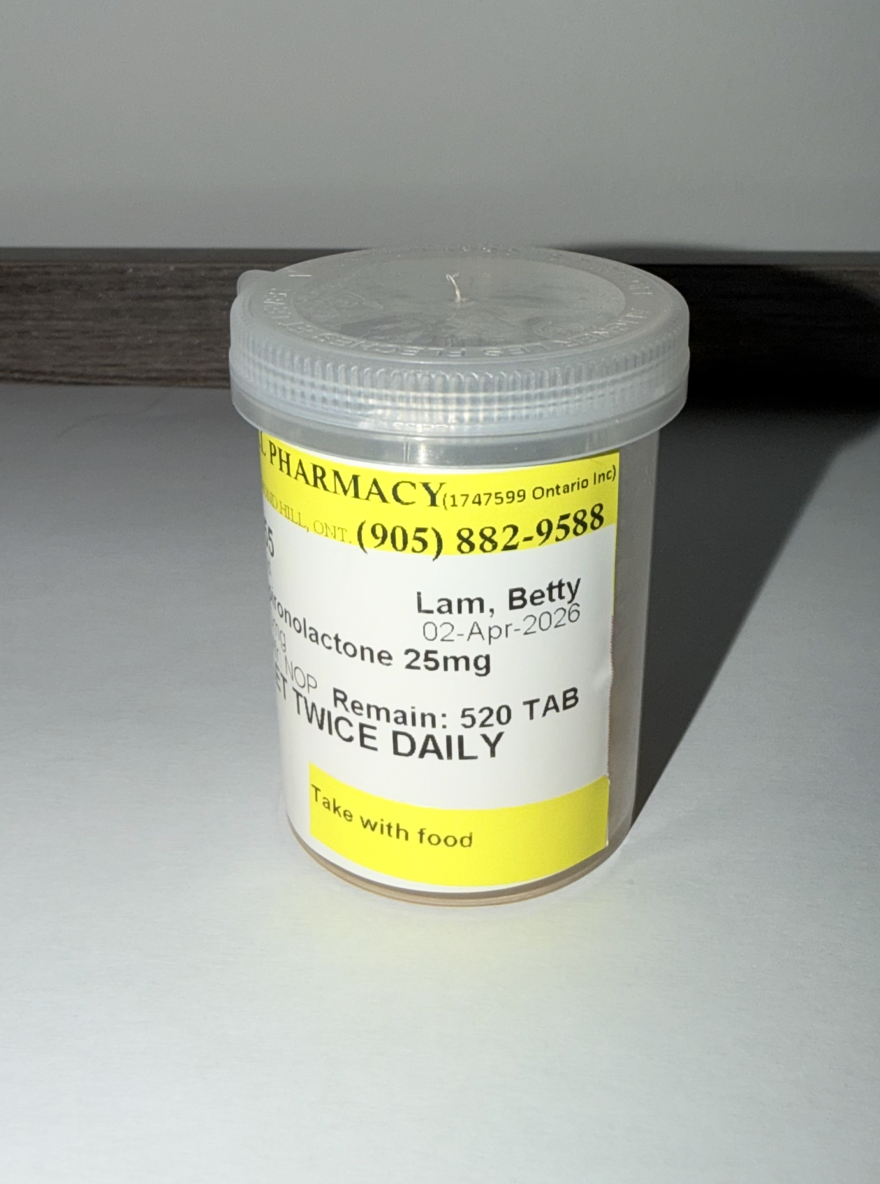 Closed pill container with circular pills inside.